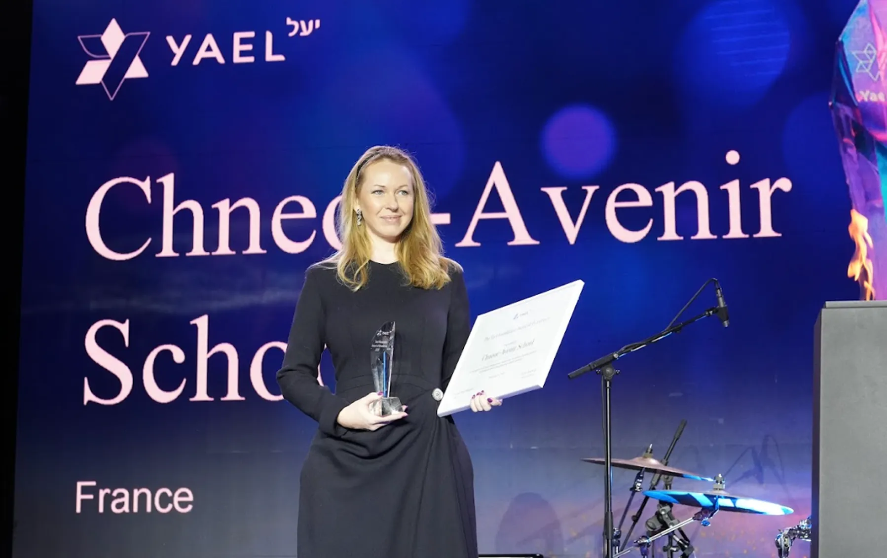 A honouree receiving a trophy and certificate