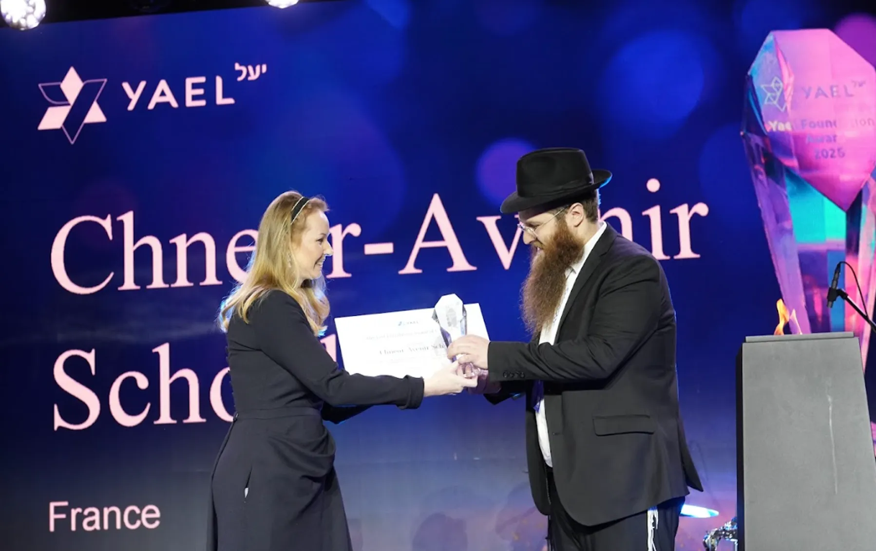 An award being handed to a school representative